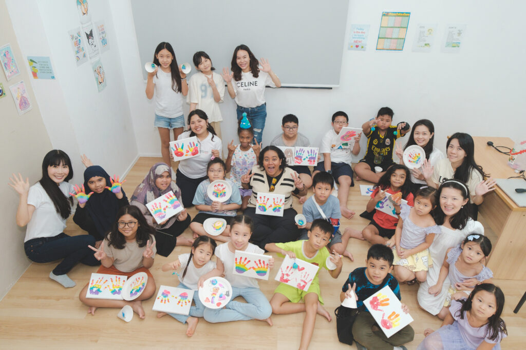 Young Hearts kids taking a group photo after an Arts and Craft session