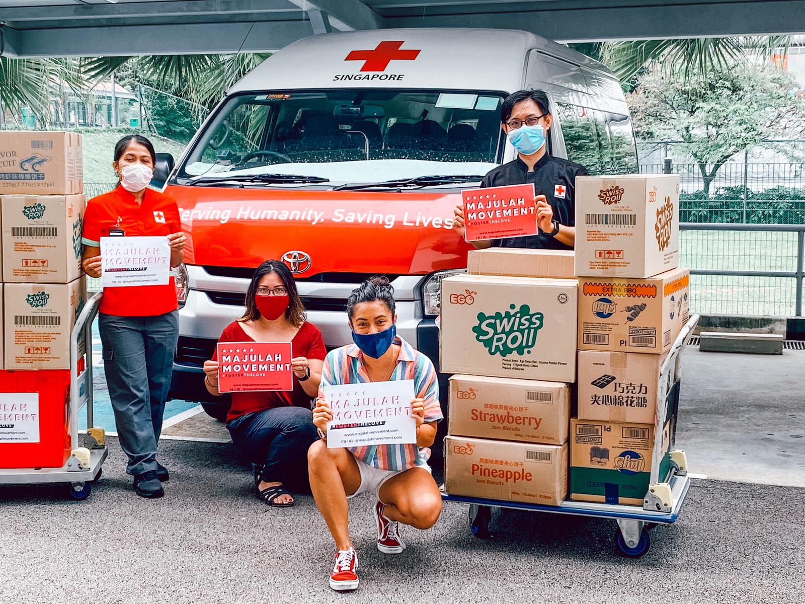 Singapore Red Cross staff and volunteers posing with donations