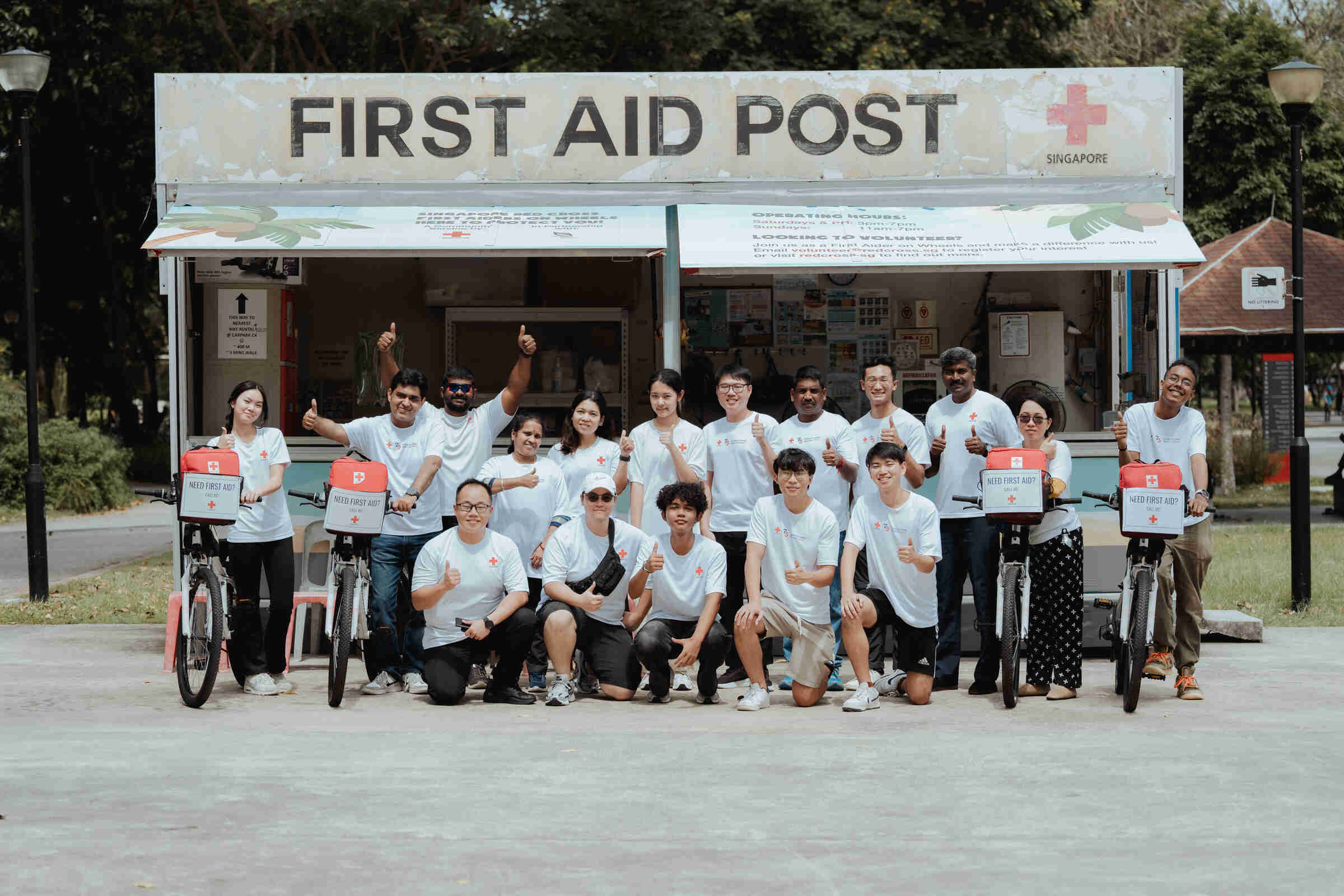 A group of First Aider on Wheels taking a group photo outside their First Aid post