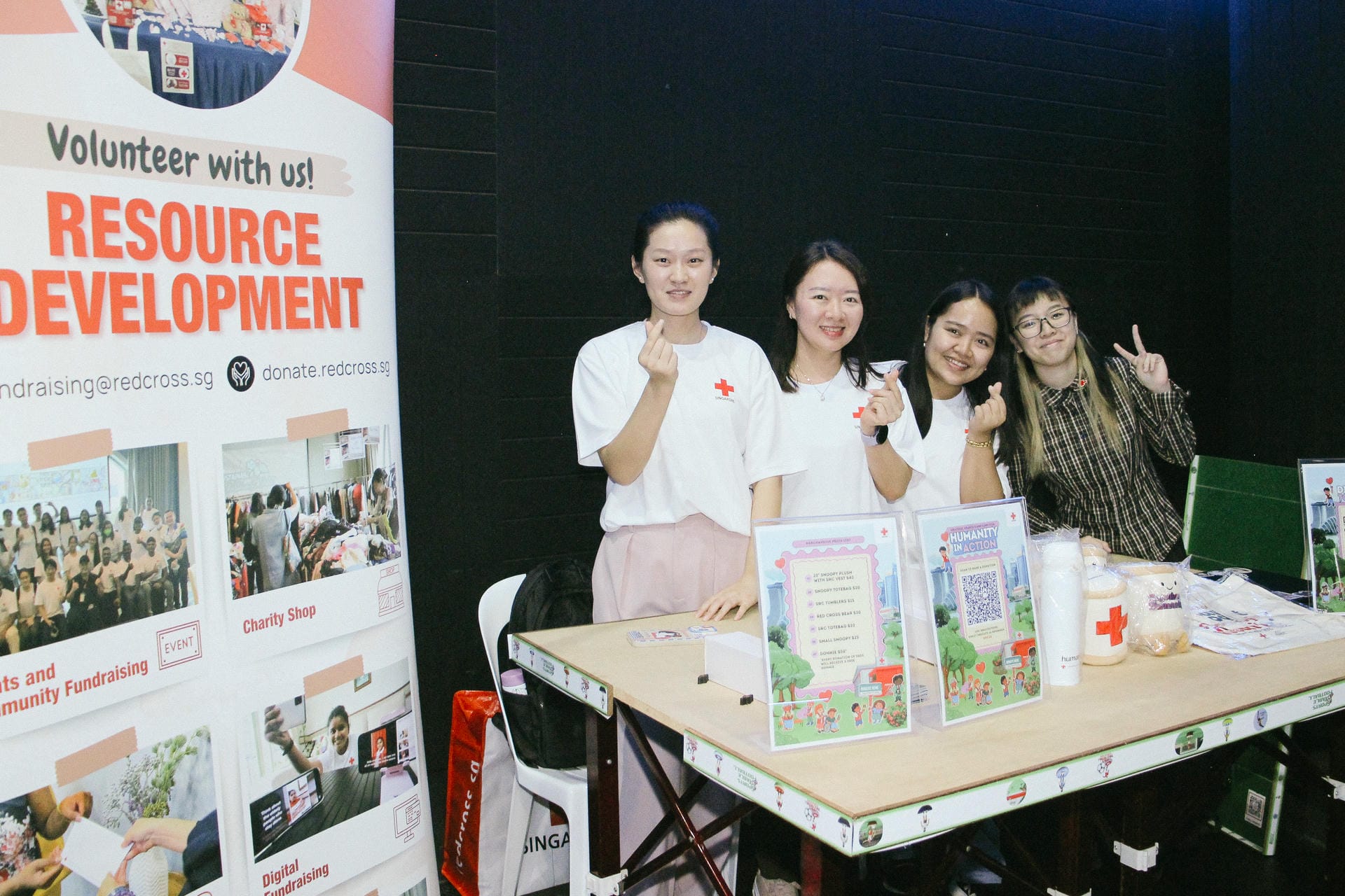 Singapore Red Cross volunteers posing at a fundraising booth