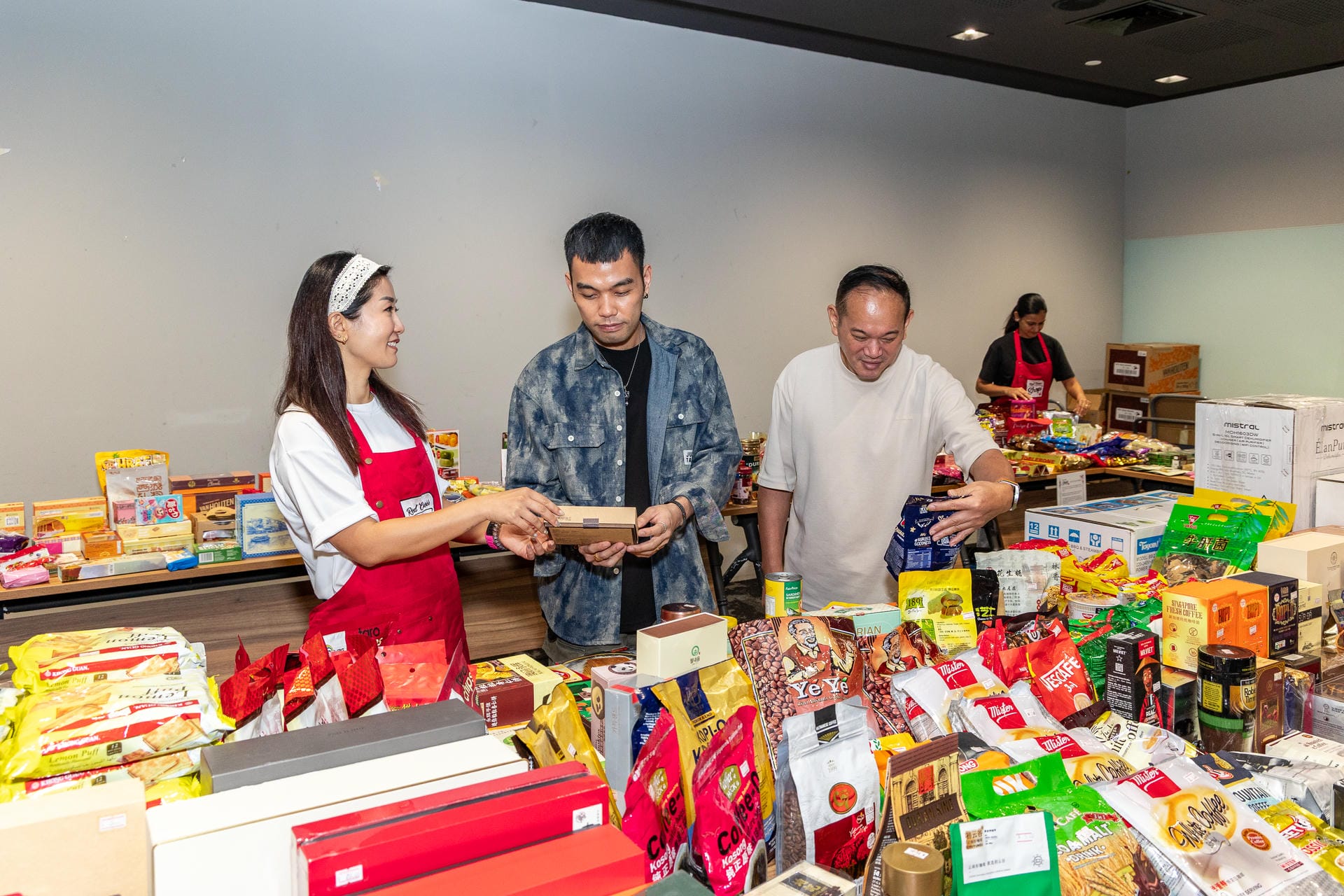 Singapore Red Cross volunteer engaging a customer at the pop-up shop