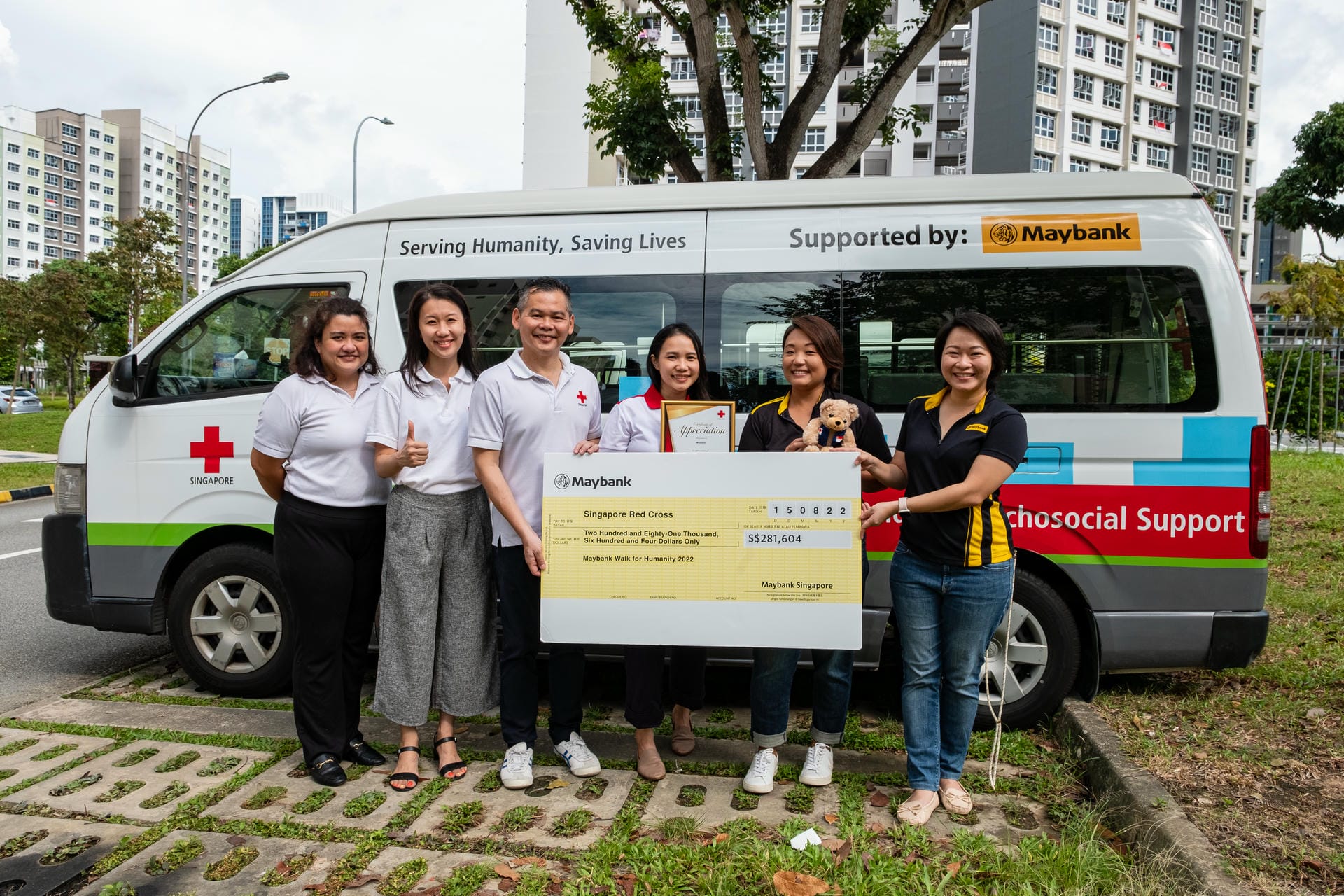 Singapore Red Cross staff with a corporate partner