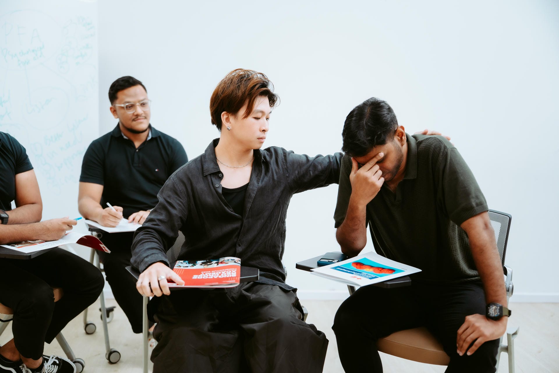 Person comforting someone else Group PFA Singapore Red Cross Academy