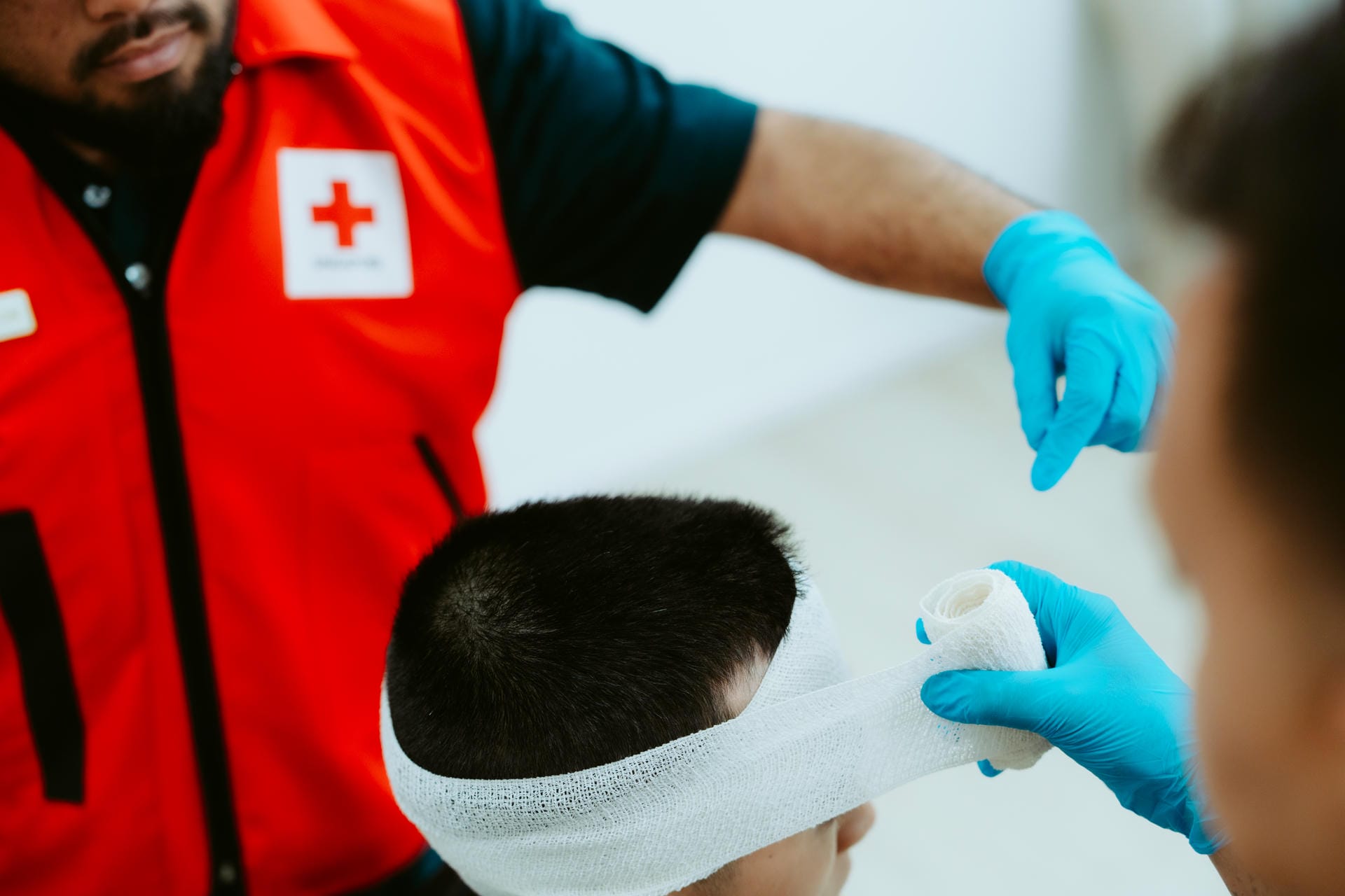 Trainers teaching head bandaging for Standard First Aid Course