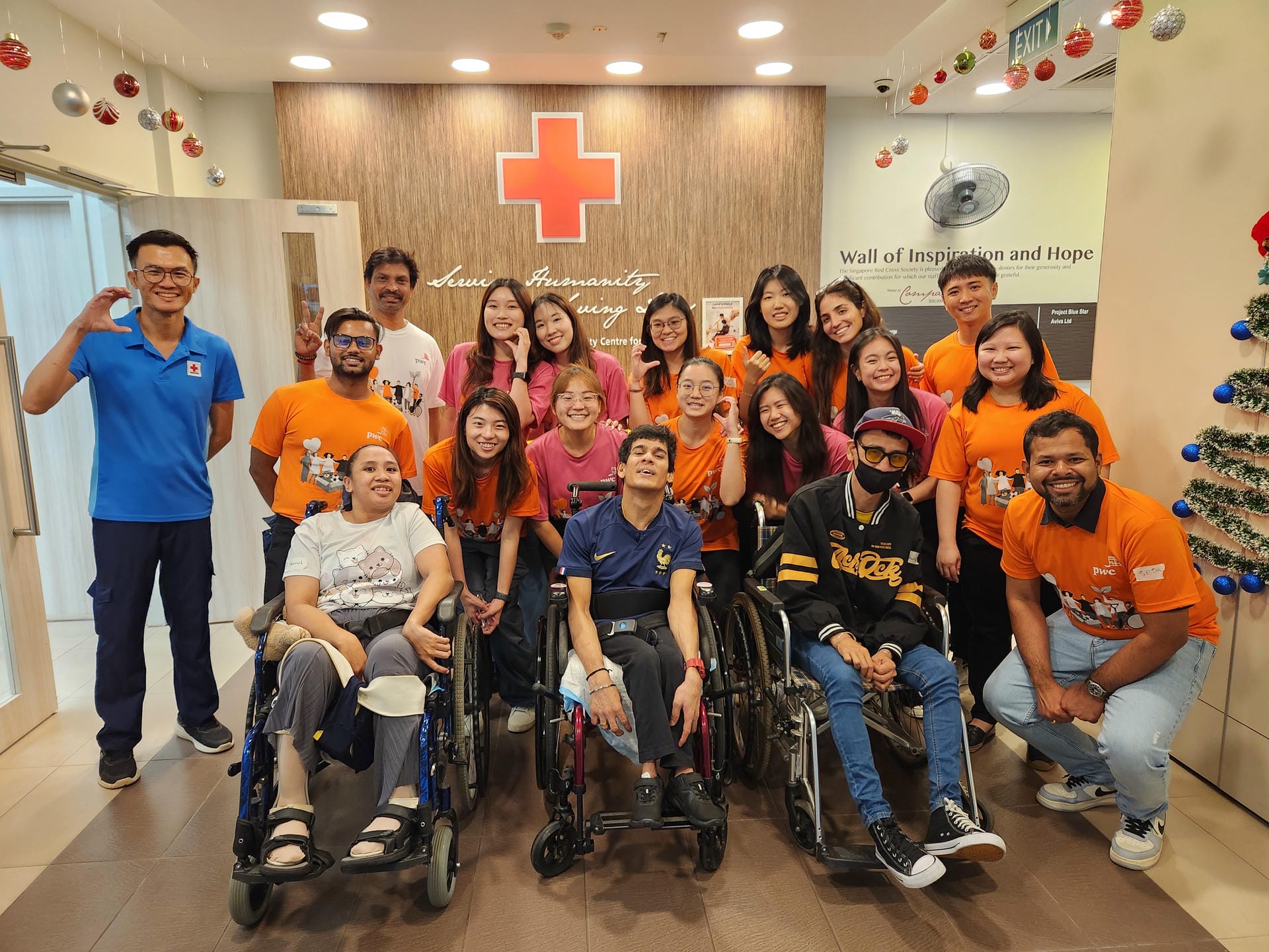 Corporate partner of the Singapore Red Cross taking a group photo at the Red Cross Home for the Disabled