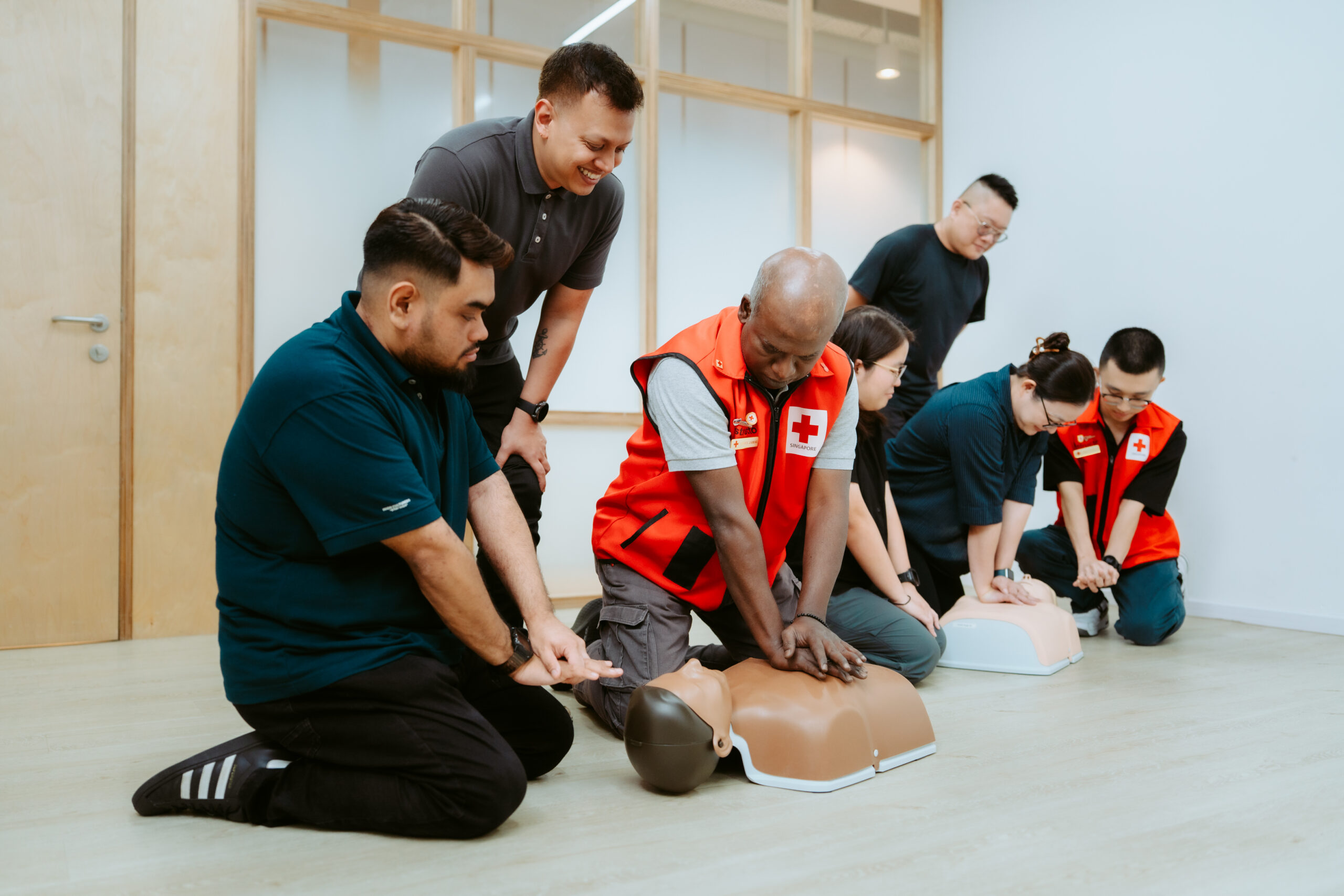 People practising CPR during first aid and resuscitation training in Singapore