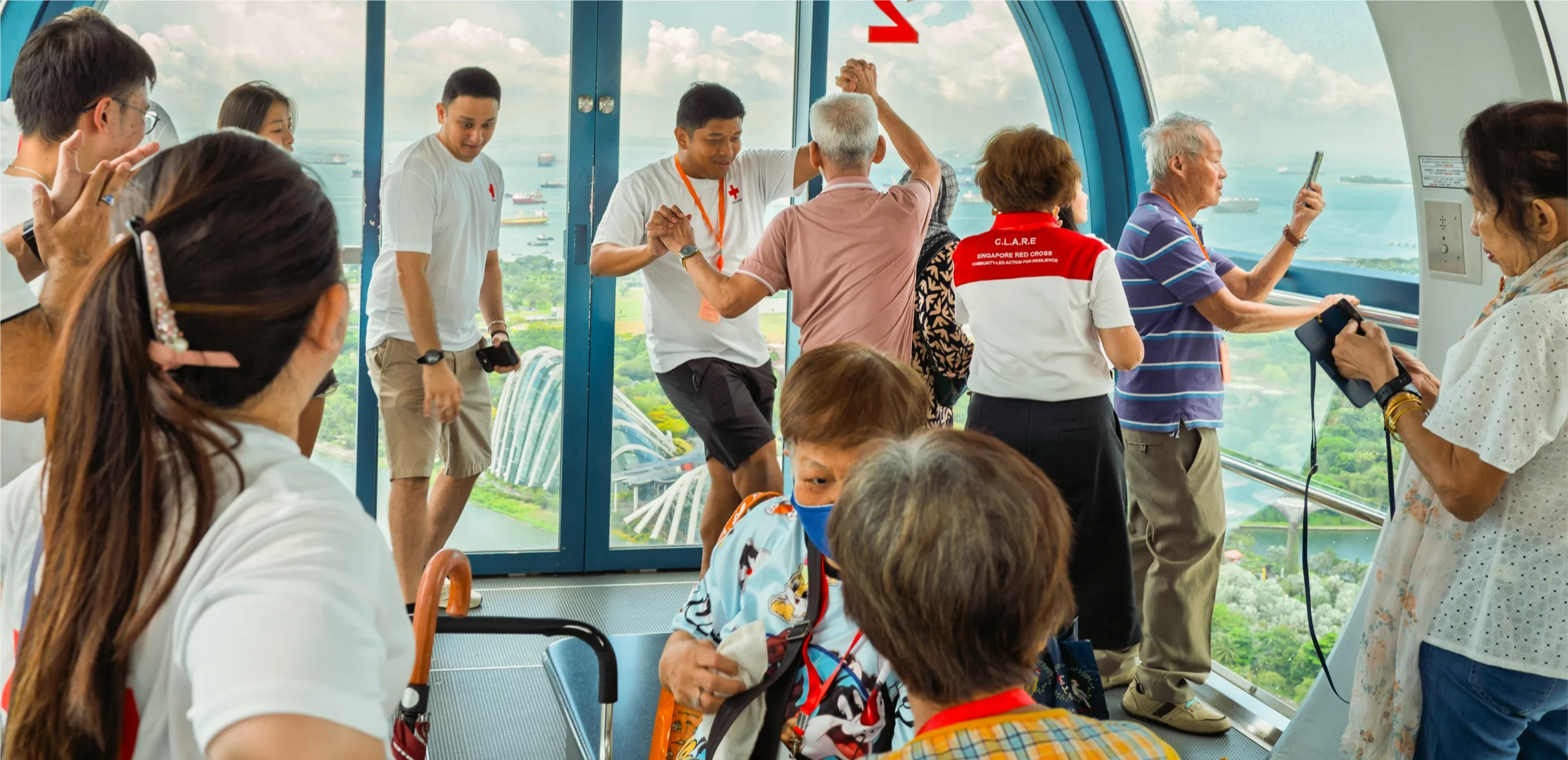 A Singapore Red Cross Shop volunteer engaging shoppers at a pop-up collaboration with our corporate partner.